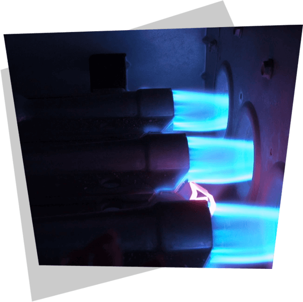 A close up of blue flames coming out of a furnace.